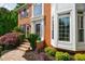 Stately brick home with a welcoming entrance, beautiful landscaping, and classic architectural details at 10830 Carrara Cv, Alpharetta, GA 30022