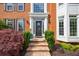 Inviting brick home with a classic front door, manicured bushes, and elegant architectural accents at 10830 Carrara Cv, Alpharetta, GA 30022