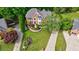 Beautiful brick home featuring a well-manicured lawn, lush landscaping, and a curved walkway at 10830 Carrara Cv, Alpharetta, GA 30022