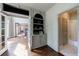 Hallway featuring built-in shelves and cabinets, hardwood floors, and a bathroom at 10830 Carrara Cv, Alpharetta, GA 30022