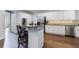 Kitchen area with white cabinets, granite countertops, stainless steel appliances, and bar stool seating at 10830 Carrara Cv, Alpharetta, GA 30022
