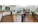 Spacious kitchen featuring granite countertops, stainless appliances, and open to dining and living areas at 10830 Carrara Cv, Alpharetta, GA 30022