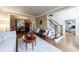 Comfortable living room with hardwood floors, elegant furniture, views to staircase, and dining area at 10830 Carrara Cv, Alpharetta, GA 30022
