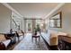 Bright living room with hardwood floors, comfortable seating, and views to the staircase at 10830 Carrara Cv, Alpharetta, GA 30022