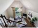 Bright living room featuring a chandelier, large window, and a cozy fireplace at 10830 Carrara Cv, Alpharetta, GA 30022