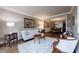 Comfortable living room with hardwood floors, elegant furniture, and open access to dining area at 10830 Carrara Cv, Alpharetta, GA 30022