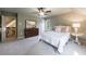 Large bedroom featuring a queen bed, dresser, and two windows providing natural light at 10830 Carrara Cv, Alpharetta, GA 30022