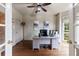 Bright home office featuring hardwood floors, neutral walls, ceiling fan, and large windows at 10830 Carrara Cv, Alpharetta, GA 30022
