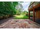 Stone patio and yard with greenery at 10830 Carrara Cv, Alpharetta, GA 30022