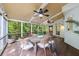 Relaxing screened porch with wood floors, ceiling fans, and peaceful wooded views at 10830 Carrara Cv, Alpharetta, GA 30022