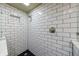 Tiled shower featuring black honeycomb floor and glass surround at 10830 Carrara Cv, Alpharetta, GA 30022