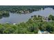 An aerial view of lakefront homes surrounded by lush trees and a community pool at 110 Westchester Way, Alpharetta, GA 30005
