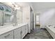 Bright bathroom features double vanity, large mirror, and separate bathtub and shower at 110 Westchester Way, Alpharetta, GA 30005