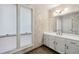 Bathroom featuring a vanity with white cabinets, a large mirror, and a linen closet at 110 Westchester Way, Alpharetta, GA 30005