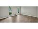 Light-filled bedroom with wood floors, two windows, and neutral color scheme at 110 Westchester Way, Alpharetta, GA 30005