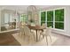 Elegant dining room featuring hardwood floors, a modern light fixture, and large windows with scenic views at 110 Westchester Way, Alpharetta, GA 30005