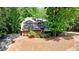 A charming two-story home with brick accents, a paved driveway and mature trees at 110 Westchester Way, Alpharetta, GA 30005