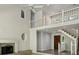 Bright living room with a fireplace, a balcony, and staircase with natural light at 110 Westchester Way, Alpharetta, GA 30005