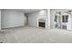 Spacious living room with carpet, a fireplace, and sliding glass doors to the outdoor deck at 110 Westchester Way, Alpharetta, GA 30005