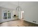 Bright living room with wood floors, modern lighting, and an archway leading to other living spaces at 110 Westchester Way, Alpharetta, GA 30005