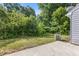 Green backyard with concrete patio and lush green foliage at 2566 Walden Lake Dr, Decatur, GA 30035