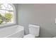 Bathroom features a window above the tub and toilet that provides natural light to the space at 2566 Walden Lake Dr, Decatur, GA 30035