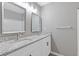 Bathroom with double sinks, granite countertops, and white cabinetry at 2566 Walden Lake Dr, Decatur, GA 30035