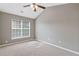 Bright bedroom features neutral colors, a ceiling fan, and a large window at 2566 Walden Lake Dr, Decatur, GA 30035