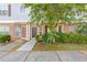 Townhome front exterior with brick facade, black front doors, and lush green bushes at 2566 Walden Lake Dr, Decatur, GA 30035