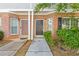 Brick townhouse exterior featuring two front doors and simple landscaping at 2566 Walden Lake Dr, Decatur, GA 30035