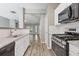 Open-concept kitchen featuring white cabinets, stainless steel appliances, and a granite countertop at 2566 Walden Lake Dr, Decatur, GA 30035