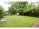 Large backyard with green lawn, garden beds, storage shed, and swing set at 1096 Tilden Nw St, Atlanta, GA 30318