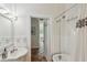 Bright bathroom featuring tile floor and a bathtub with shower at 1096 Tilden Nw St, Atlanta, GA 30318