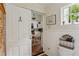 Bright bathroom with charming details including a barn door and a glimpse into the adjacent, updated kitchen at 1096 Tilden Nw St, Atlanta, GA 30318