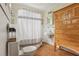 Cozy bathroom featuring a vintage-style cabinet, classic fixtures, and a shower-tub combination with stylish curtain at 1096 Tilden Nw St, Atlanta, GA 30318