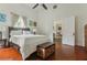 Inviting bedroom featuring a queen bed, storage chest, hardwood floors, and an open doorway to an adjacent room at 1096 Tilden Nw St, Atlanta, GA 30318