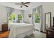 Bright bedroom featuring hardwood floors, neutral walls, large windows, and a comfortable queen bed at 1096 Tilden Nw St, Atlanta, GA 30318
