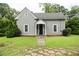 Charming home featuring a well-manicured lawn, gray siding, and a cozy front porch at 1096 Tilden Nw St, Atlanta, GA 30318