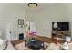 Spacious living room with beautiful hardwood floors, fireplace, and a large flat screen television at 1096 Tilden Nw St, Atlanta, GA 30318