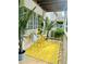 Cozy balcony featuring a bright yellow rug, bistro set, and lush greenery, perfect for outdoor relaxation at 1990 Wellbourne Dr # 5, Atlanta, GA 30324