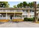 Multi-Gathering home with white siding, a covered balcony, designated parking, and mature trees at 1990 Wellbourne Dr # 5, Atlanta, GA 30324