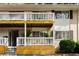 Multi-Gathering home with white siding, a covered balcony, designated parking, and mature trees at 1990 Wellbourne Dr # 5, Atlanta, GA 30324
