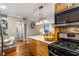 Eat-in kitchen featuring wooden cabinets, stainless appliances, and a view into the living room at 1990 Wellbourne Dr # 5, Atlanta, GA 30324