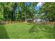 Large, well-manicured lawn enclosed by a wooden fence at 3275 Dodson Dr, East Point, GA 30344