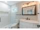 Bathroom featuring a glass shower, a white marble vanity and a large framed mirror at 3275 Dodson Dr, East Point, GA 30344