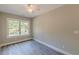 Empty bedroom featuring laminate wood floors and large window at 3275 Dodson Dr, East Point, GA 30344