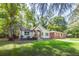 Charming home featuring mature trees and manicured lawn at 3275 Dodson Dr, East Point, GA 30344
