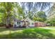 Charming home featuring a well-maintained lawn, surrounded by mature trees at 3275 Dodson Dr, East Point, GA 30344
