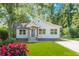 Charming single-Gathering home featuring a manicured lawn, lovely landscaping, and inviting front porch at 3275 Dodson Dr, East Point, GA 30344