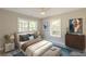 Cozy bedroom features a plush bed, matching nightstands, and large windows for natural light at 3275 Dodson Dr, East Point, GA 30344